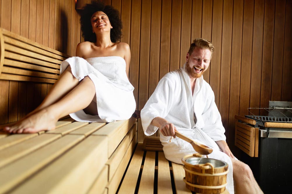 couple resting and sweating in sauna